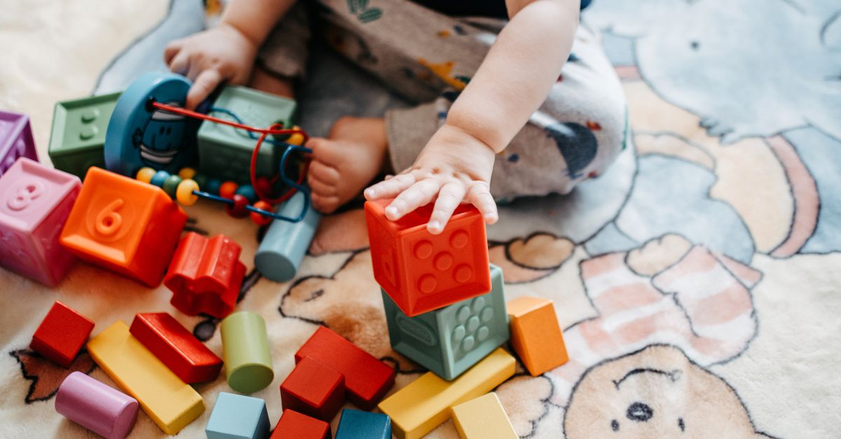 Young children playing and learning in a bright early years classroom setting