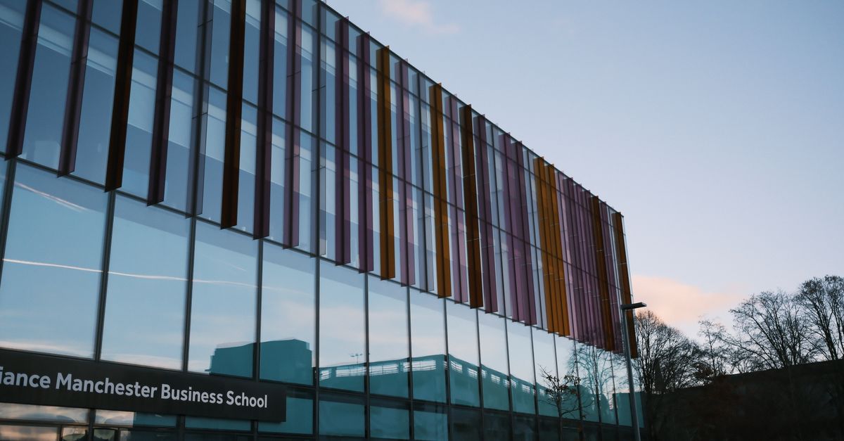 Students walking across a university campus in Manchester