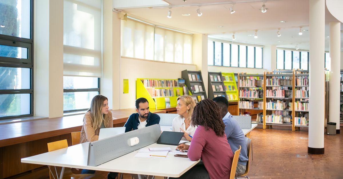 Researcher and industry professional working together at a desk in a modern office
