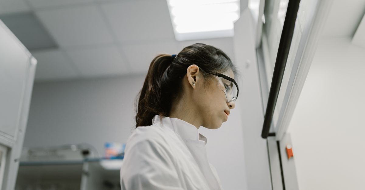 A researcher working at a university laboratory bench