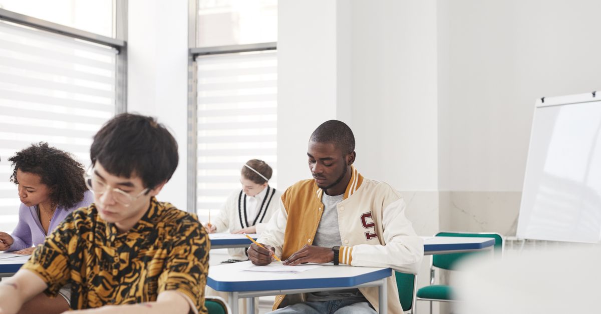 Students sitting an exam in a large university examination hall