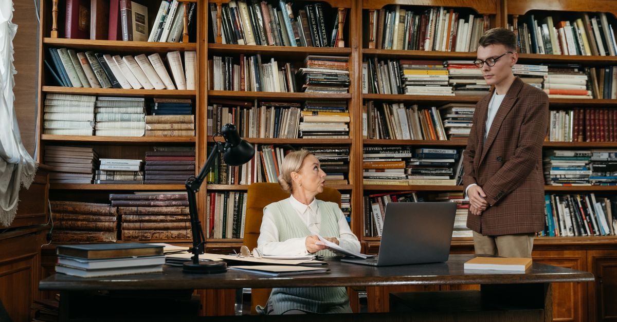 Two academics having a conversation in a university office